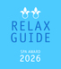 A blue square design displays white text reading "RELAX GUIDE SPA AWARD 2026," framed by two stylized floral motifs at the top, suggesting a prestigious recognition.