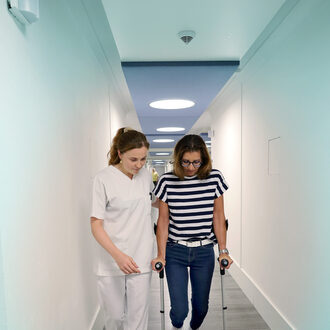 Two women are interacting in an office setting.